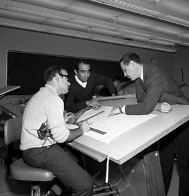 Photograph of a Drafting instructor with his students