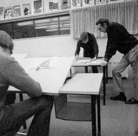 Photograph of Ron Geard Assisting Students at the Drawing Table