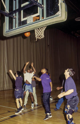 A photograph of a group of students playing basketball