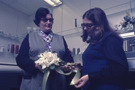 Two unknown women with a floral arrangement : [photograph]