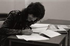Photograph of a person writing on paper