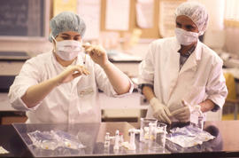 Photograph of a Pharmacy Assistant Students Preparing a Syringe