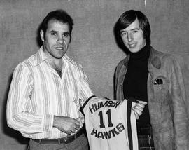 Photograph of Rick Bendera Presenting a Jersey to a Student