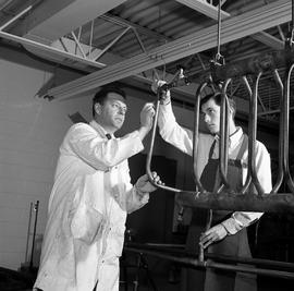 Photograph of an instructor guiding a student with an unknown unit
