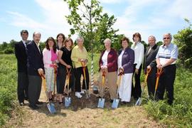 Officials doing a ceremonial planting at Ecology Centre opening : [photograph]