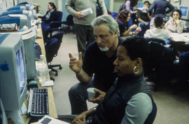 Photograph of Professor Carey French assisting a student with an assignment