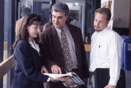 Photograph of an instructor and students posed in a hallway