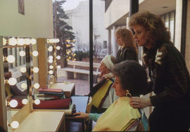 Photograph of students and clients in the makeup studio