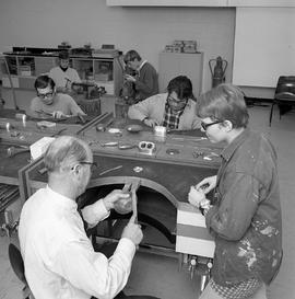 Photograph of Creative Art students in a metal shop making bowls