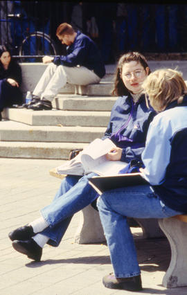 A photograph of students sitting in the courtyard