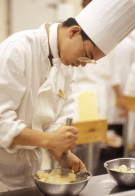 Photograph of a student in the Culinary program mixing ingredients