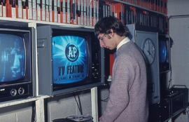 Photograph of a Technician providing video distribution services to classrooms from the IMC