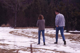 Photograph of two people on a snowy pathway in the Arboretum