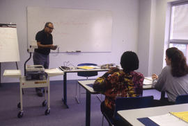 Photograph of an Instructor Lecturing in a Classroom