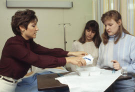 Photograph of a Nursing instructor demonstrating with students