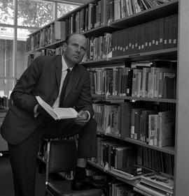 Photograph of David Pugsley in the library at James S. Bell