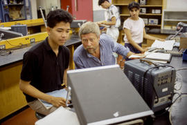 Photograph of an instructor and student in an electronics lab