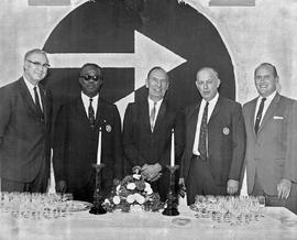 Photograph of Ted Jarvis, Gordon Wragg, and Jim Davis Standing Next to Members of St. Vincent Gre...