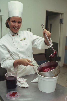 Photograph of a student preparing food to serve in the Humber Room