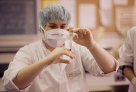 Photograph of a Pharmacy Assistant Student Preparing a Syringe