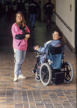 Photograph of a nursing student and a disabled student engaged in a conversation