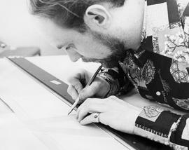 Photograph of a Student Working on a Project on a Drafting Table