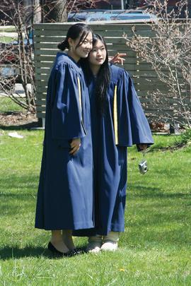 Photographs of two students in graduation gowns