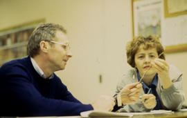 A photograph of a floriculture student examining a twig
