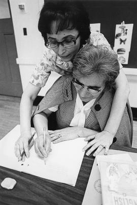 Photograph of Jenny Graham Assisting a Student in an ESL Class
