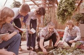 Students and Faculty member Jim Walmsley in plant nursery : [photograph]