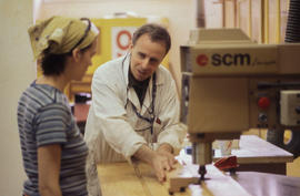 Photograph of Mark Paddison showing student how to use equipment