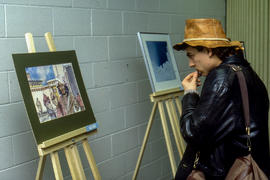 Photograph of Someone Looking at Student Art