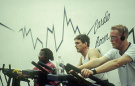 A photograph of gym-goers using fitness equipment