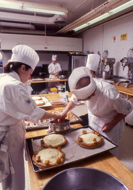 Photograph of Culinary program students dipping pastries