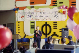 Photograph of Sue Johanson and students gathered in the concourse