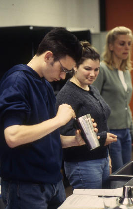 A photograph of a student in the Bartending lab mixing a drink