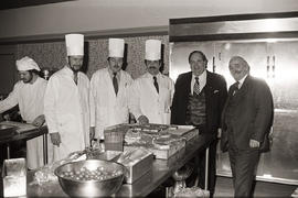 Photograph of Igor Sukor, Larry Holmes and chefs in the kitchen