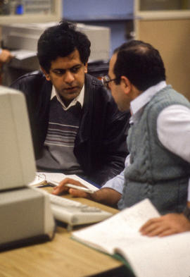 Photograph of two adult learners at a computer stations