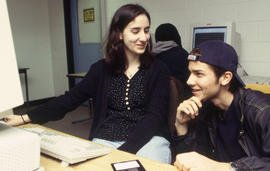 A photograph of two students working in the computer lab