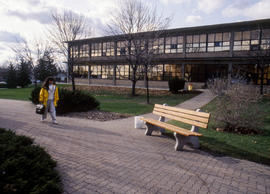 Photograph of a student walking through the courtyard at Lakeshore campus