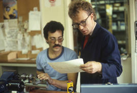 Photograph of an instructor and student working in a precision instrumentation lab