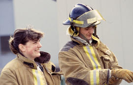 A photograph of two firefighting students in full gear