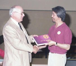 Photograph of Gordon Wragg presenting "Past and Presence" to Wayson Choy