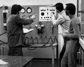 Photograph of Students Working with an Electro Fluid Tester in the Lab