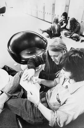 Photograph of Students Sitting on the Floor Talking in Building D