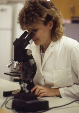 Photograph of a Nursing student working with microscope