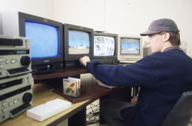 Photograph of a Media Studies student working at an audio-visual console
