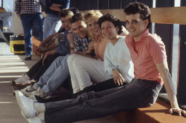 Photograph of a group of students sitting on a ledge