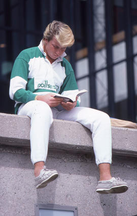 Photograph of a student reading outside the main stairwell