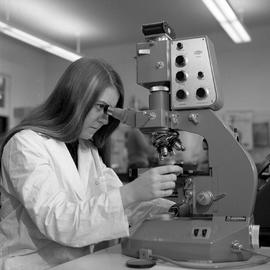 Photograph of a chemical technology student using a microscope